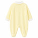 Soft yellow baby pyjama with white collar and cuffs, shown flat on a white background.