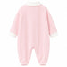 Baby pyjama in light pink with white cuffs and collar, shown flat on a white background.