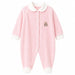 Pink baby pyjama with white trim and teddy bear embroidery, laid flat on a white background.