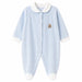 Light blue baby pajama with white cuffs and collar, teddy bear patch on chest, shown on white background.