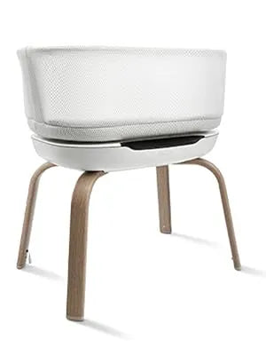 Graco® SmartSense™ Soothing Bassinet with breathable mesh sides and woodgrain legs.