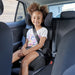Harmony Dreamtime Elite High Back Booster car seat shown with child seated in the back of a vehicle.