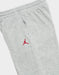 Jordan kids' grey sweatpants with red Jumpman logo, shown flat on a white background.
