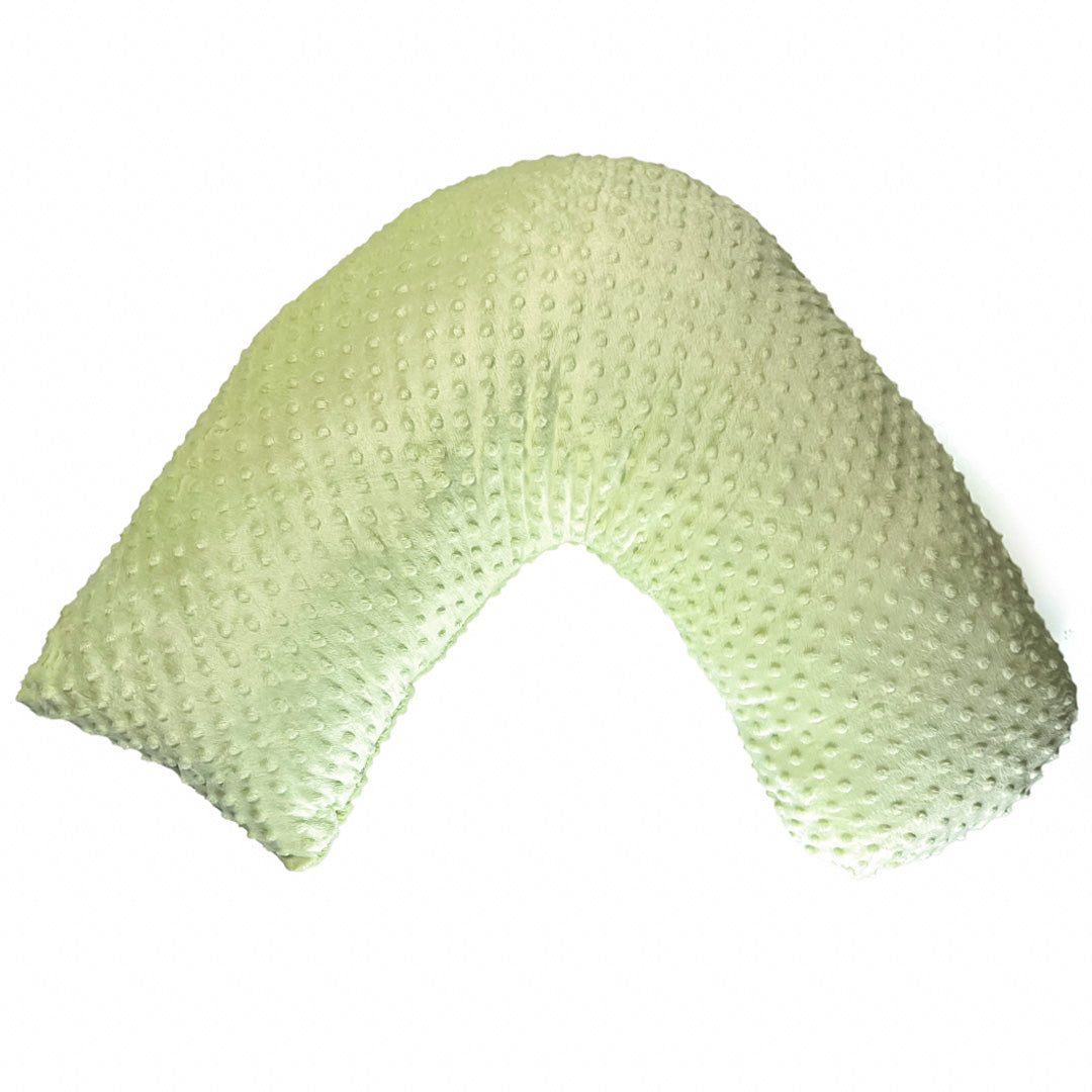 Pale green boomerang-shaped nursing pillow with textured dot pattern on white background