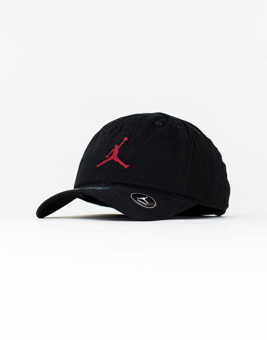 Jordan youth black strapback cap with red logo, displayed on a white background.