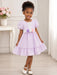 Kids Energy Floral Lilac Dress worn by a little girl standing and smiling in a bright room.