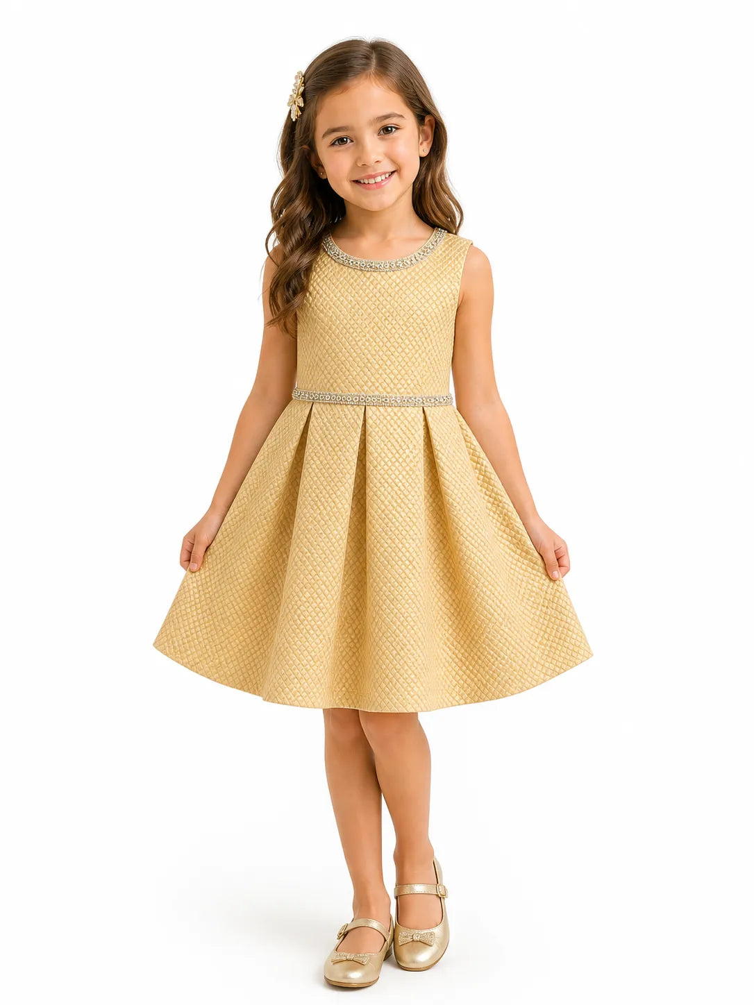 Kids Energy gold rhinestone textured dress worn by a girl standing and smiling against a white background.