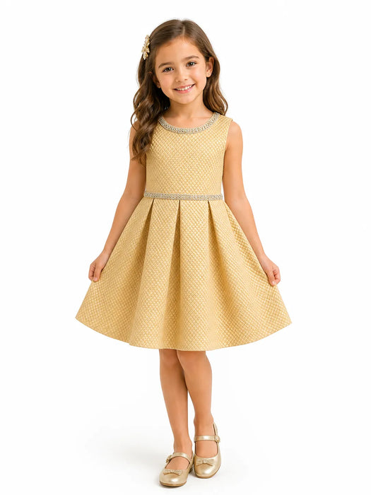 Kids Energy gold rhinestone textured dress worn by a girl standing and smiling against a white background.