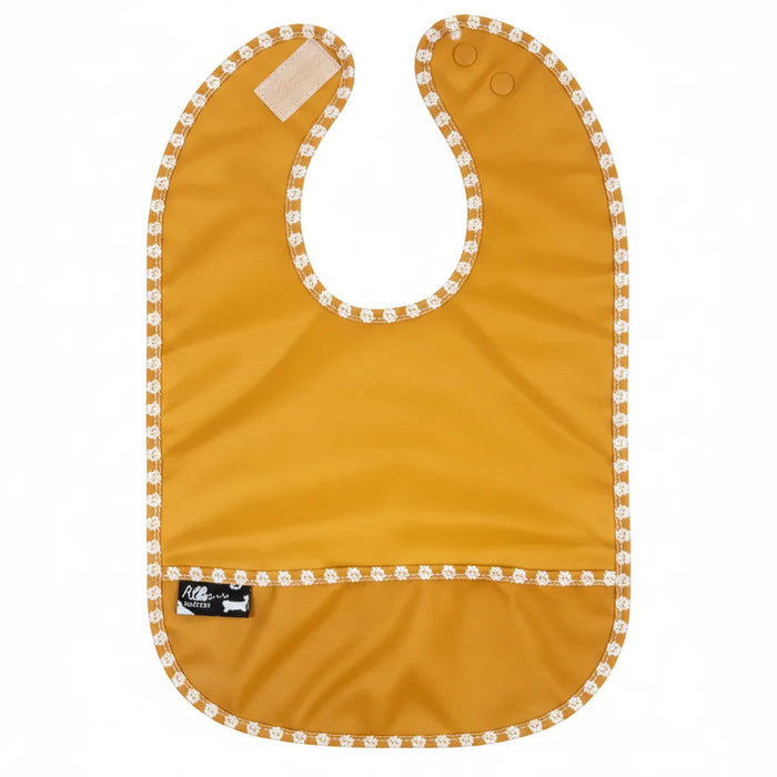Orange waterproof baby bib with pocket and snap closure, white floral trim