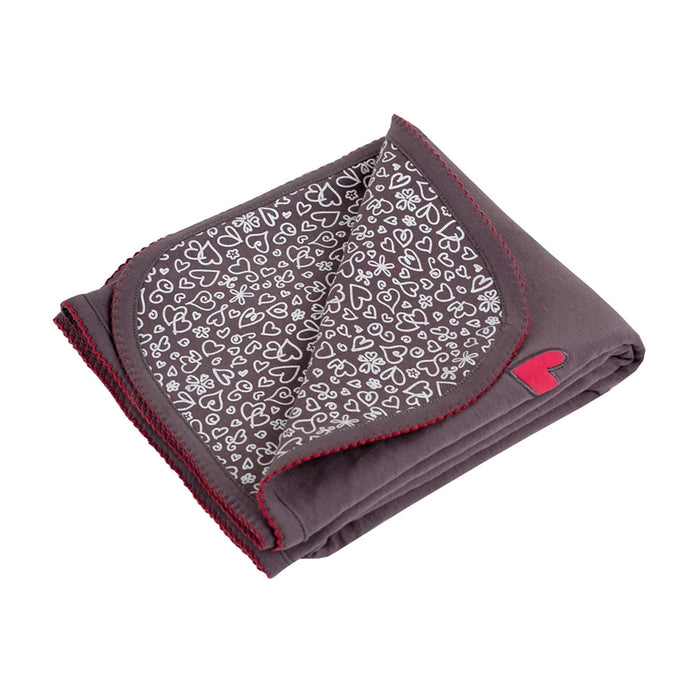 Kushies I Heart You blanket displayed folded, showing grey fabric with white heart patterns and red trim.