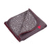 Kushies I Heart You blanket displayed folded, showing grey fabric with white heart patterns and red trim.
