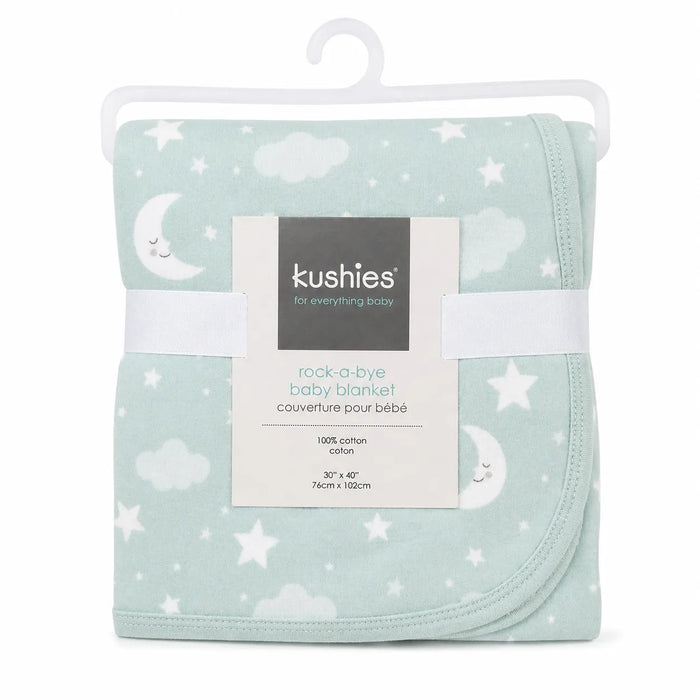 Kushies rock-a-bye baby blanket folded on a hanger, featuring a moon and stars pattern.