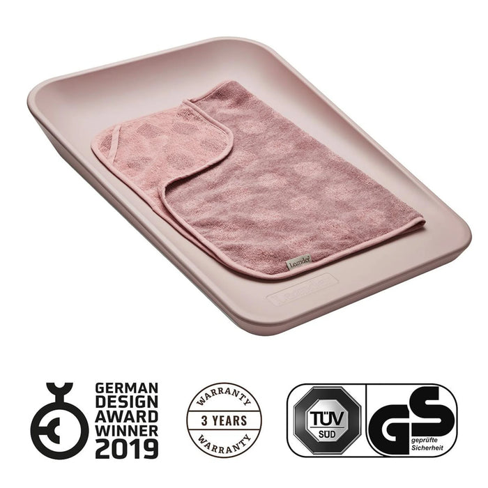 Leander Matty baby changing waterproof mat with a pink towel placed on top, shown on a white background.