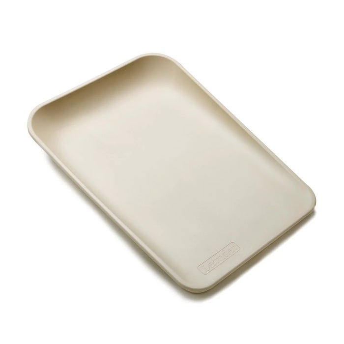 Leander Matty baby changing waterproof mat in beige shown angled on a white background.