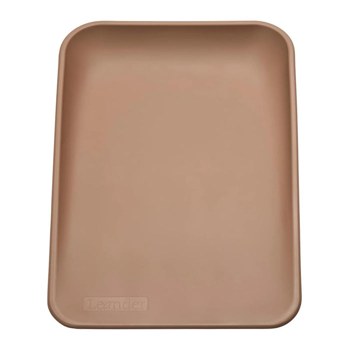 Leander Matty baby changing waterproof mat in brown shown from above on a plain background.