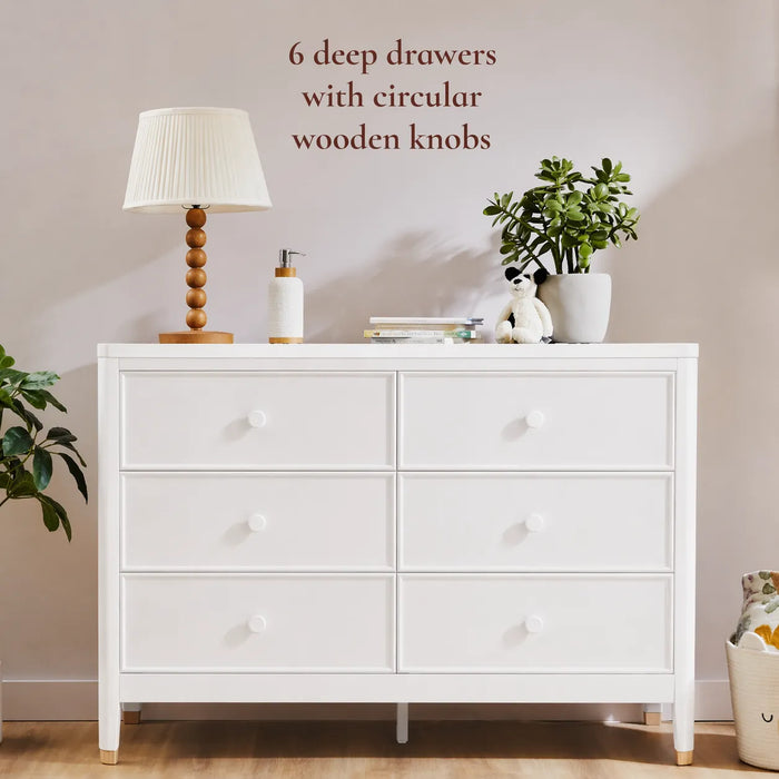 Little Seeds Aster dresser with six drawers, circular wooden knobs, styled in a modern nursery setting.