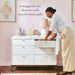 Little Seeds Laurel 6 Drawer Dresser shown in a pink nursery with a woman opening a drawer.