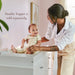 Little Seeds Laurel 6-Drawer Dresser shown in a nursery with a woman changing a smiling baby on top.