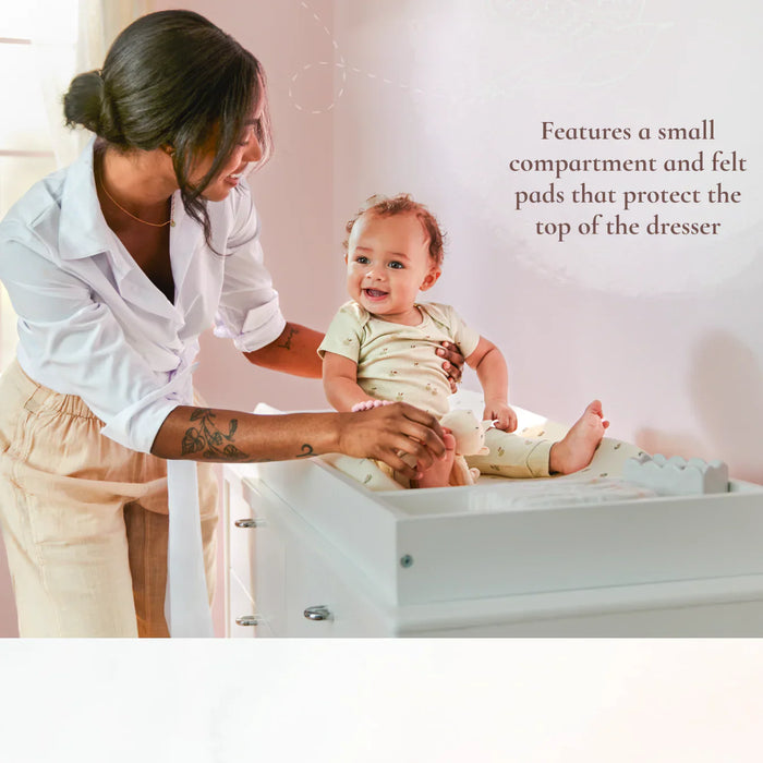 Little Seeds Laurel dresser topper shown in use as a baby changing station with a smiling child.
