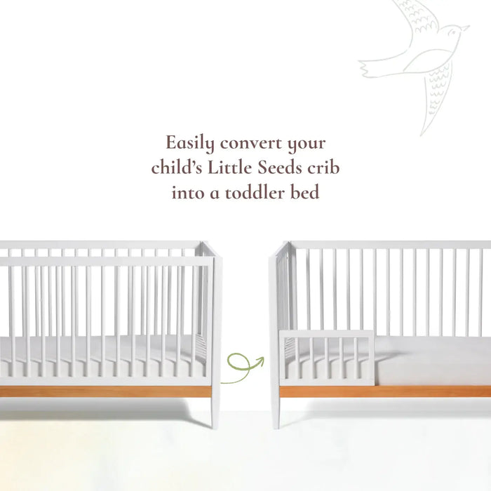 Little Seeds Spindle Guardrail shown converting a white crib into a toddler bed with wooden base.