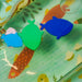 Manhattan Toy Riverbend Water Play Mat with colorful fish shapes floating on the mat surface.