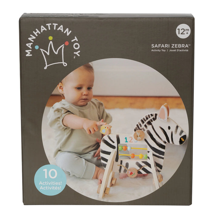 Manhattan Toy Safari Zebra wooden activity toy shown with a baby playing on a soft carpeted floor.