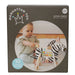 Manhattan Toy Safari Zebra wooden activity toy shown with a baby playing on a soft carpeted floor.
