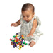 Manhattan Toy Skwish Wooden Rattle Teether shown with a baby sitting and playing on a white background.