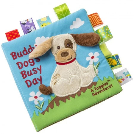 Taggies Soft Book Teddy Dog shown closed with colorful ribbon tags and an embroidered dog on the cover.