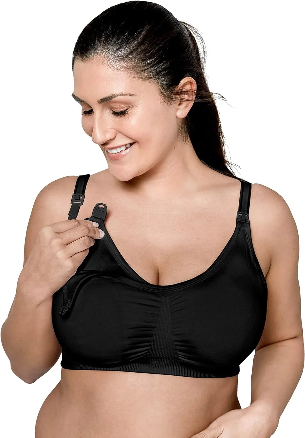 Woman wearing a black nursing and pumping bra, unclipping strap for breastfeeding access