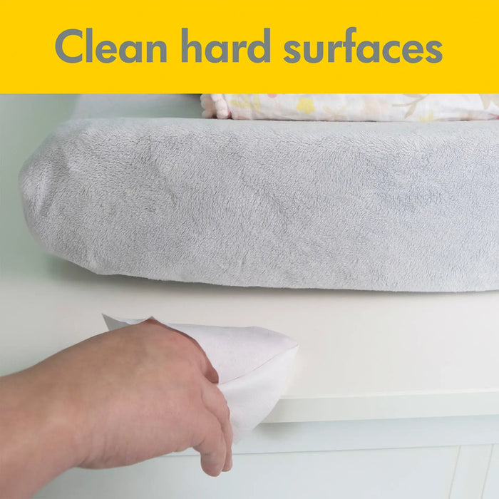 Medela Quick Clean breast pump wipes cleaning a white hard surface near a soft changing pad.