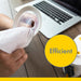 Medela Quick Clean breast pump wipe cleaning pump part on a wooden table near a laptop.