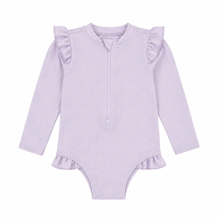 Baby rashguard swimsuit in light purple with long sleeves, floral pattern, and ruffle details, shown flat.