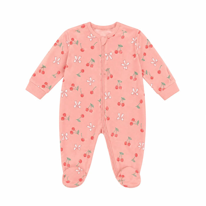 Mid Comfort baby pyjama in pink, decorated with cherry and bow prints, displayed on a white background.
