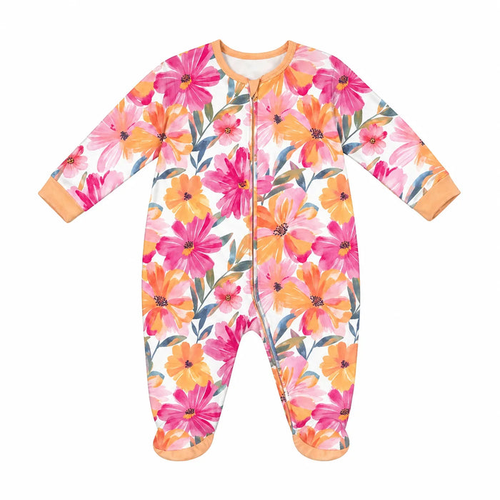 Mid-comfort baby pyjama with bright pink and orange floral pattern laid flat on a white background.