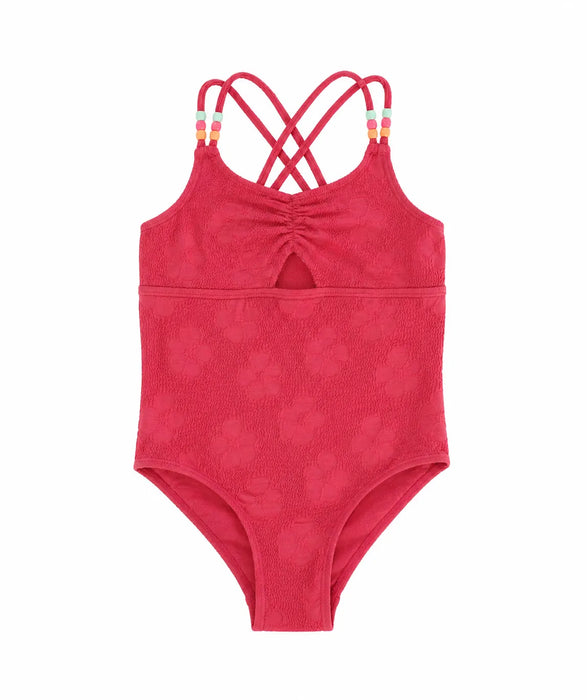 Kids red one-piece swimsuit with textured floral pattern and beaded crisscross straps, shown on white background.