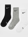 Nike Dri-FIT cushioned crew socks in black, grey, and white laid out side by side on a white background.