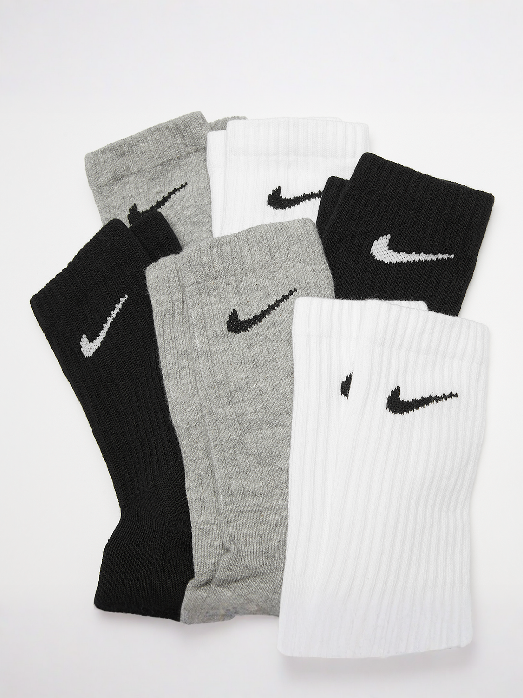 Nike Dri-FIT cushioned crew socks six-pack in black, grey, and white, laid flat on a white surface.