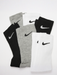Nike Dri-FIT cushioned crew socks six-pack in black, grey, and white, laid flat on a white surface.