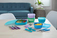 NUK suction bowls 2-pack in teal and blue, displayed with lids and kids’ utensils on a dining table.