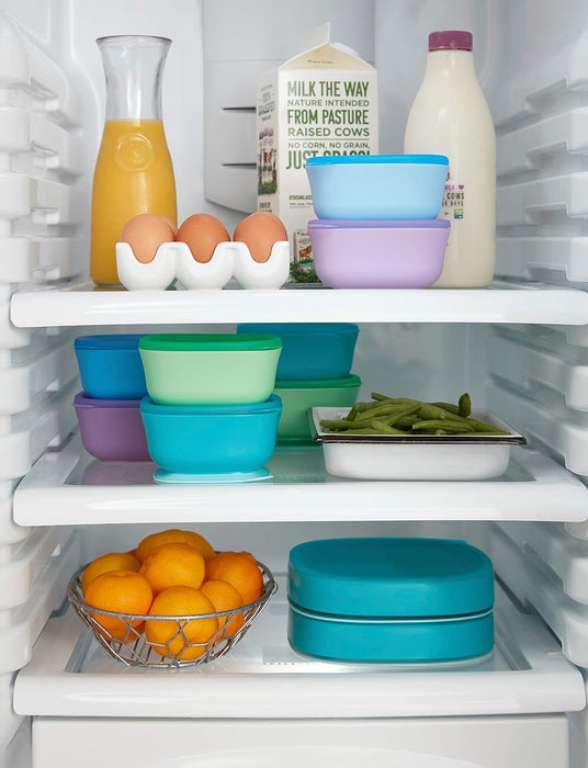 NUK suction bowls 2-pack in teal shown stacked inside a refrigerator with assorted food items.