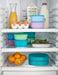 NUK suction bowls 2-pack in teal shown stacked inside a refrigerator with assorted food items.
