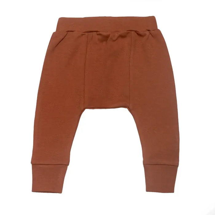 Parade Organics cotton baby harem pants in brown laid flat on a white background.