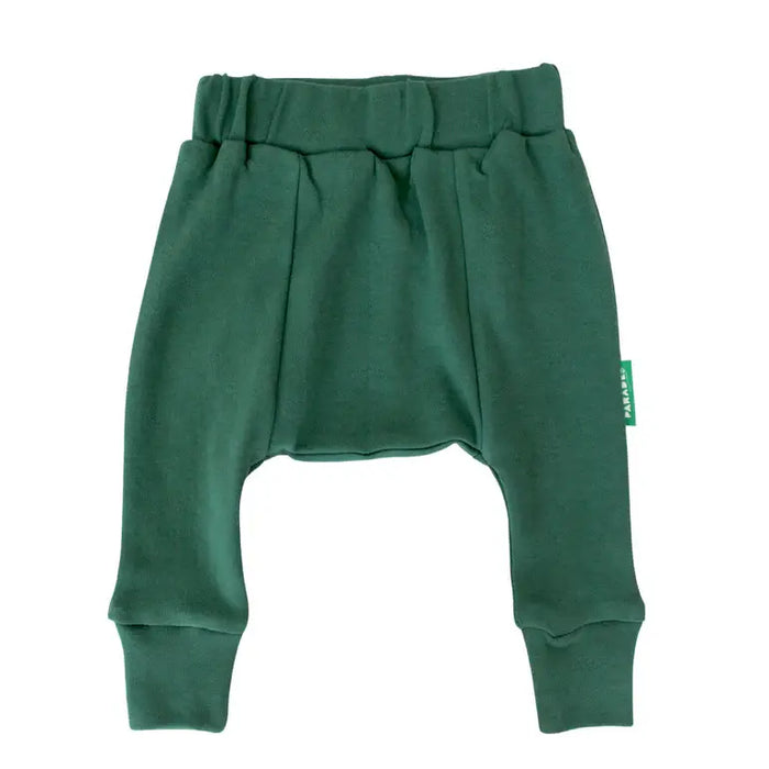 Parade Organics cotton baby harem pants in solid green laid flat on a white background.