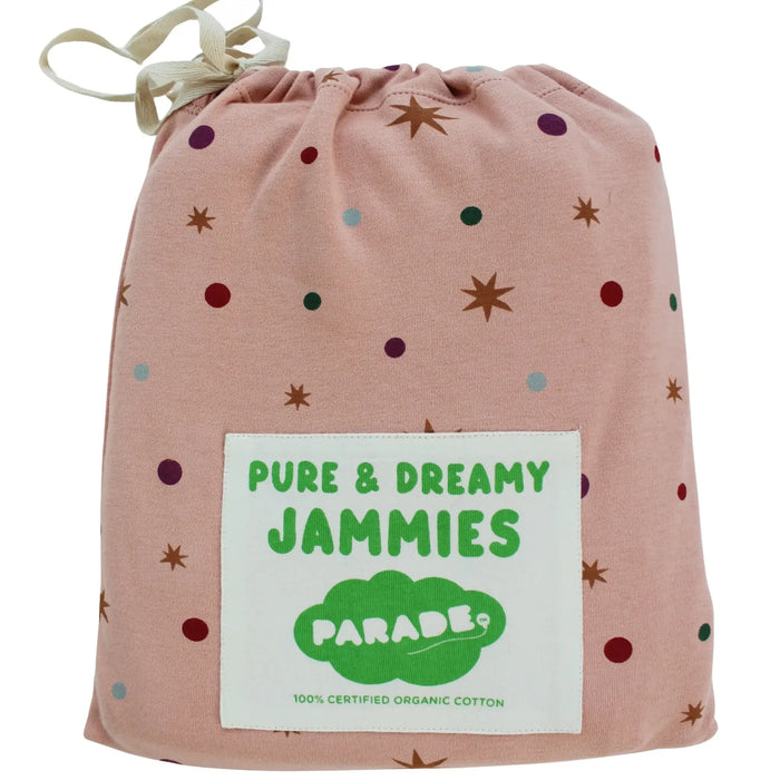 Parade Organics organic cotton jammies in a pink drawstring bag with star and dot pattern.
