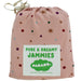 Parade Organics organic cotton jammies in a pink drawstring bag with star and dot pattern.