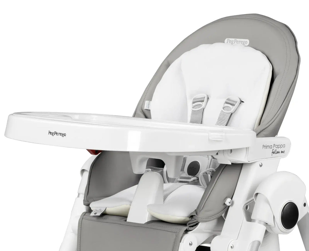 Peg Perego Prima Pappa high chair with white booster cushion and harness, shown in profile view.