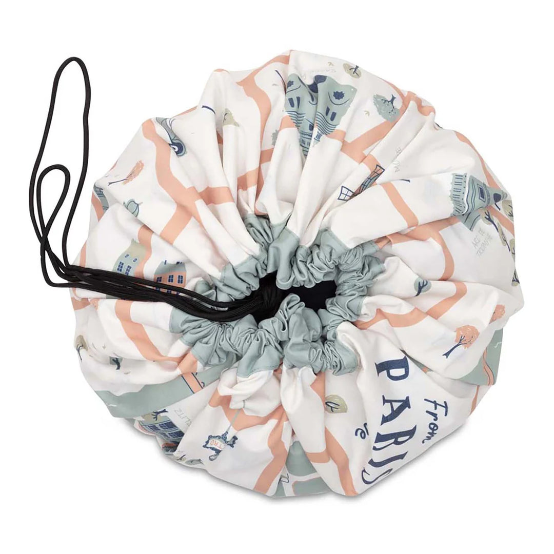 Drawstring play mat or storage bag with Paris-themed print for kids, pastel colors.