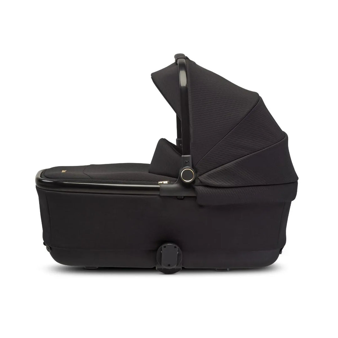 Black baby bassinet with canopy, side view, suitable for newborns and strollers