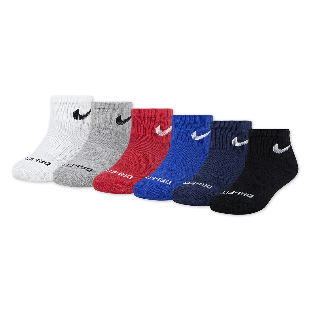 Assorted Nike boys' ankle socks in white, gray, red, blue, navy, and black, laid out in a row.